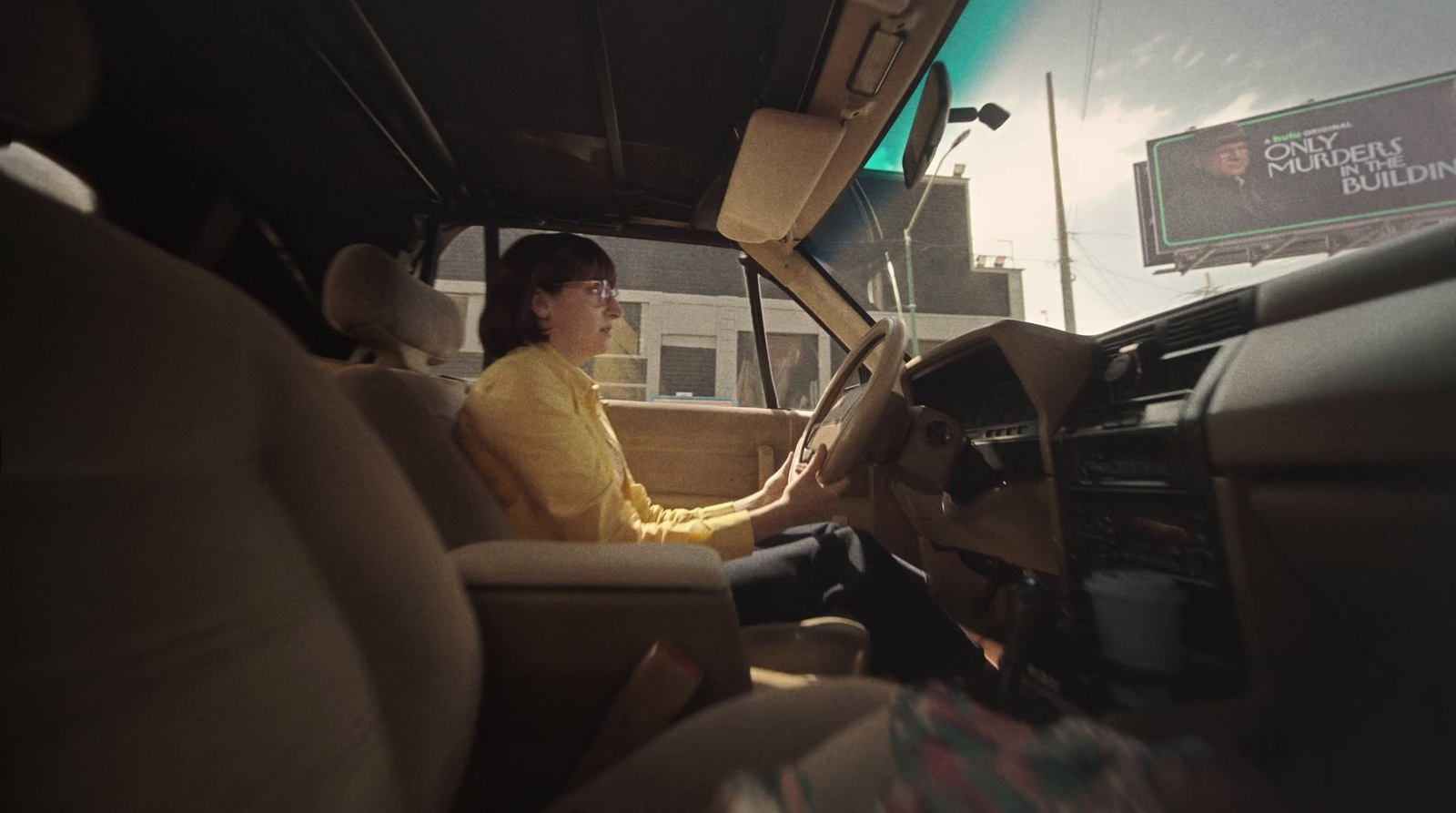 a woman sitting in the driver's seat of a vehicle