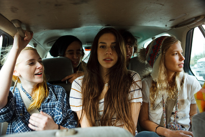 a group of young women riding in the back of a van