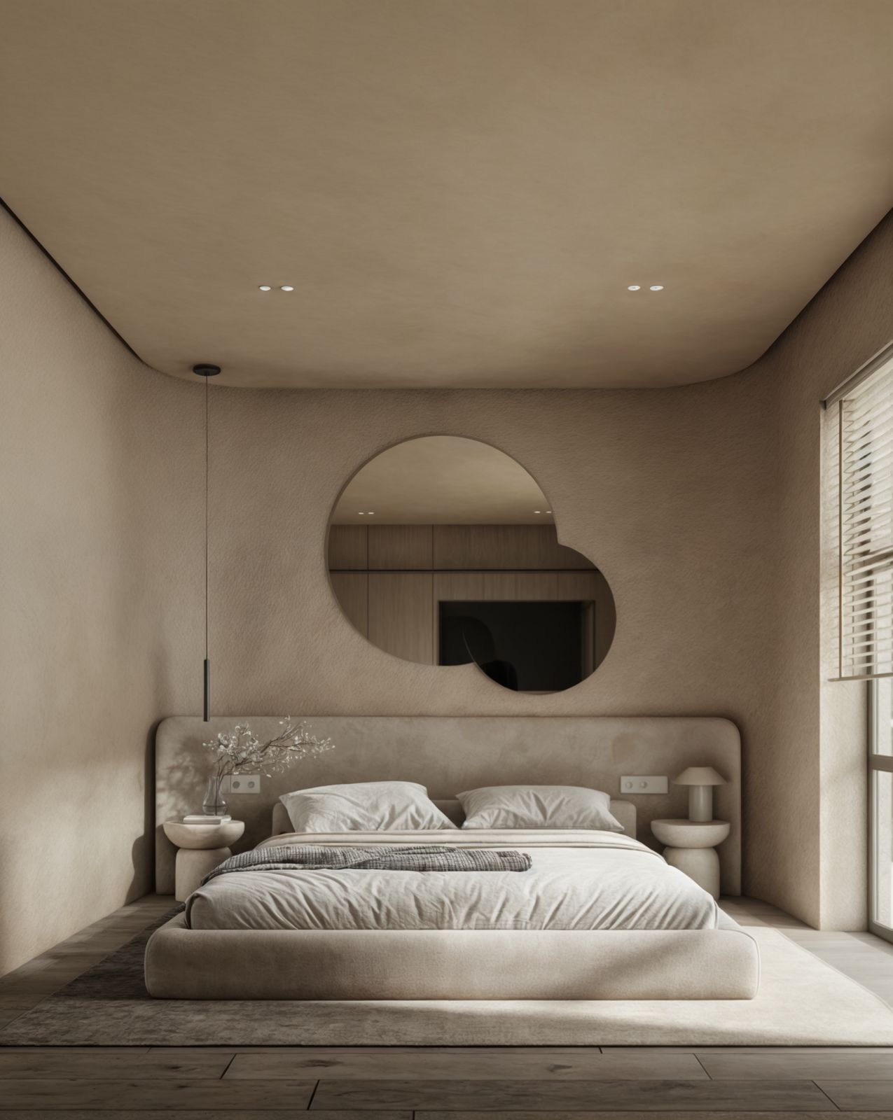 a bedroom with a large bed and a round mirror