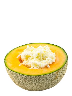 a melon with a scoop of cream on top of it