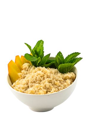 a bowl of oatmeal with mint and peach slices