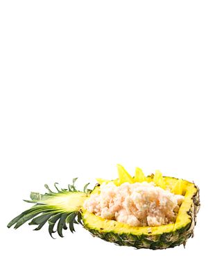 a pineapple filled with food sitting on top of a white table