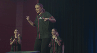 a group of young women standing on top of a stage