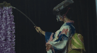 a woman in a kimono holding an umbrella