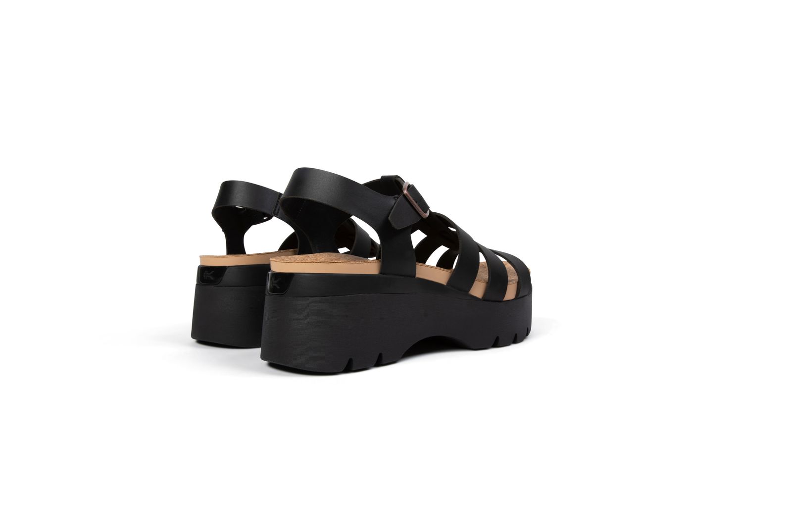 a pair of black platformed sandals on a white background