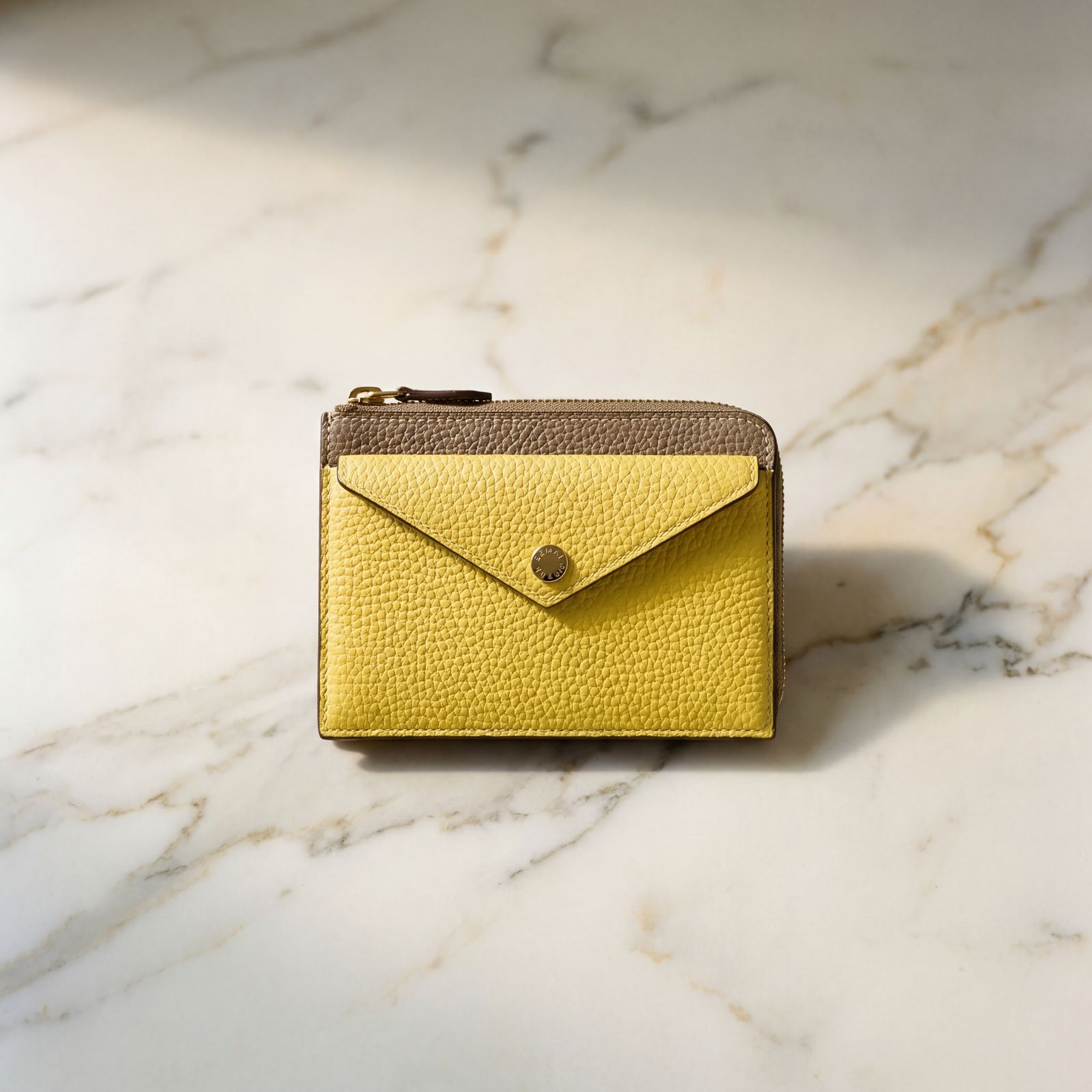 a small yellow purse sitting on top of a marble counter