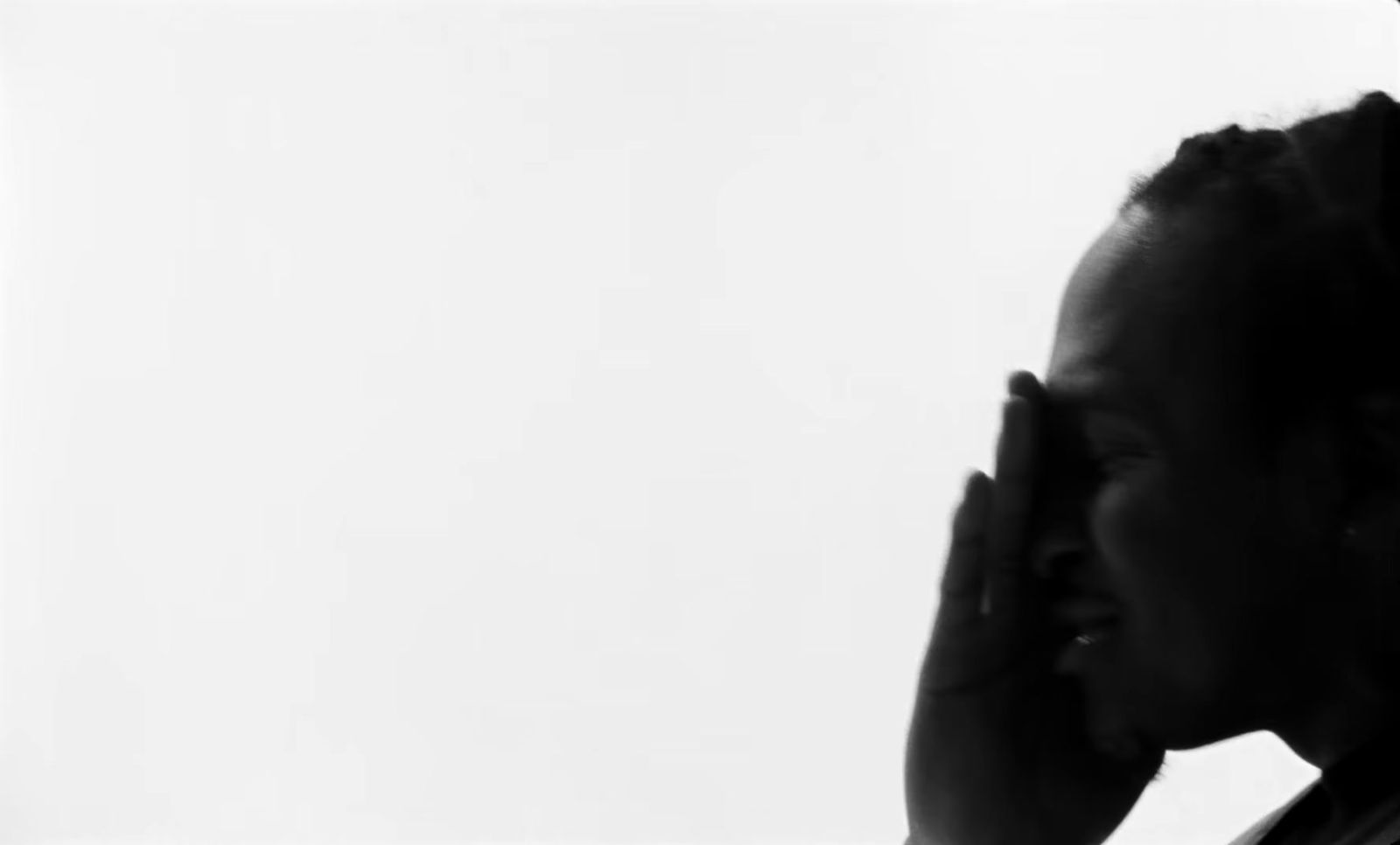 a black and white photo of a woman talking on a cell phone