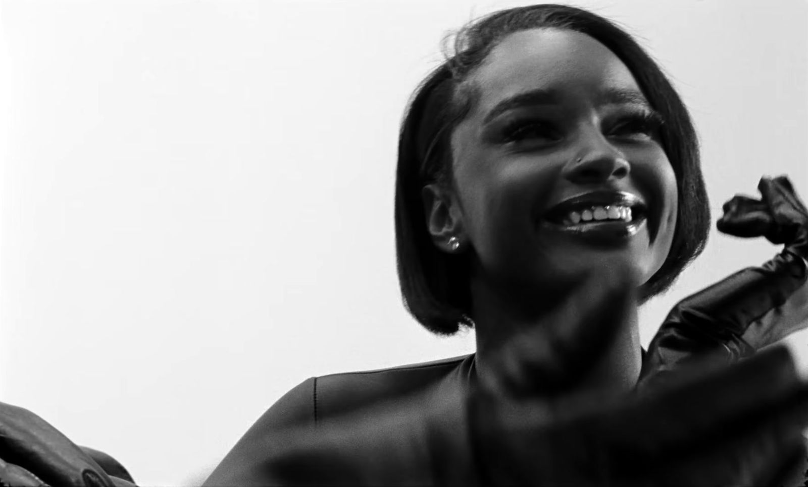 a black and white photo of a woman holding a microphone