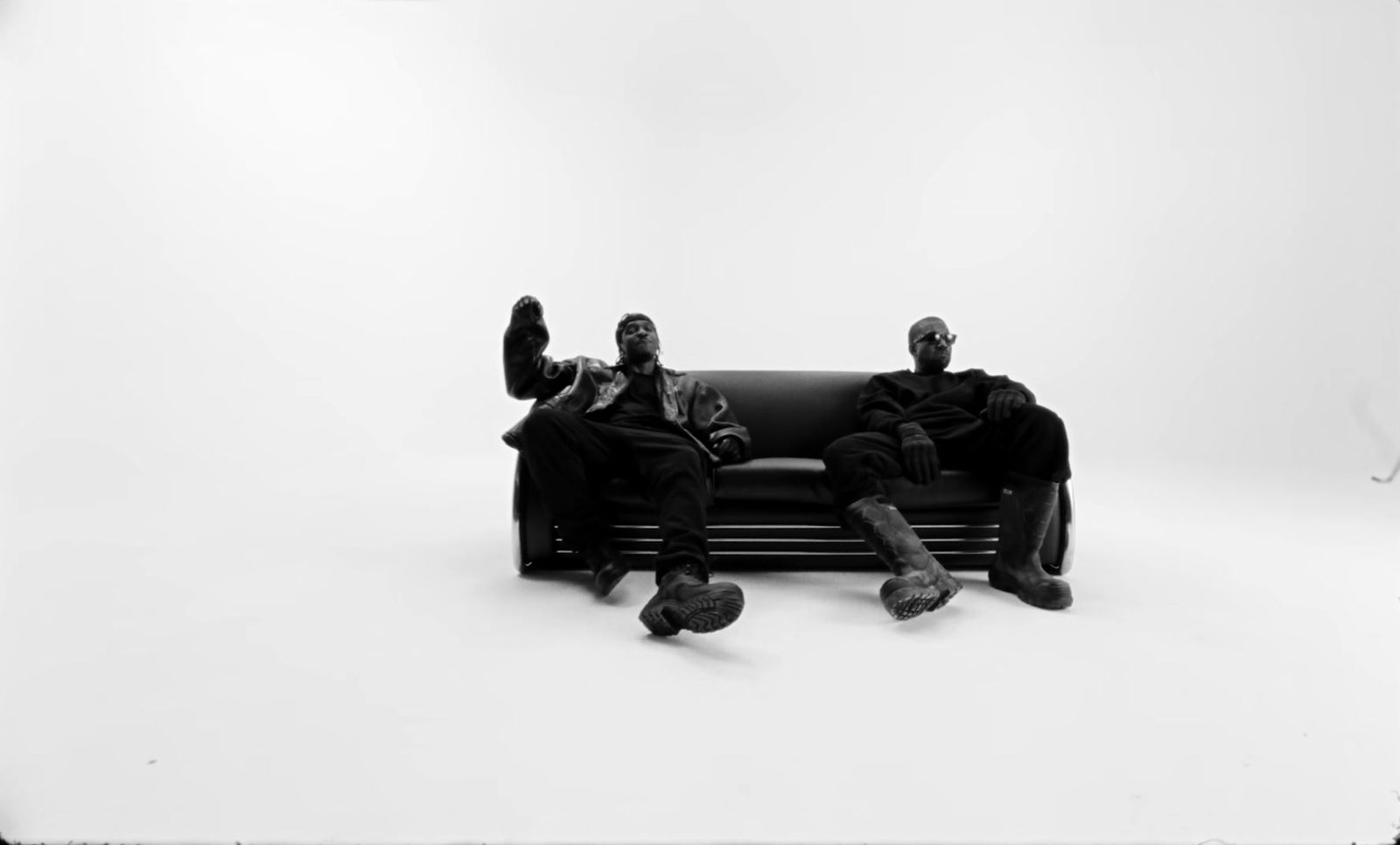 a couple of people sitting on top of a black couch