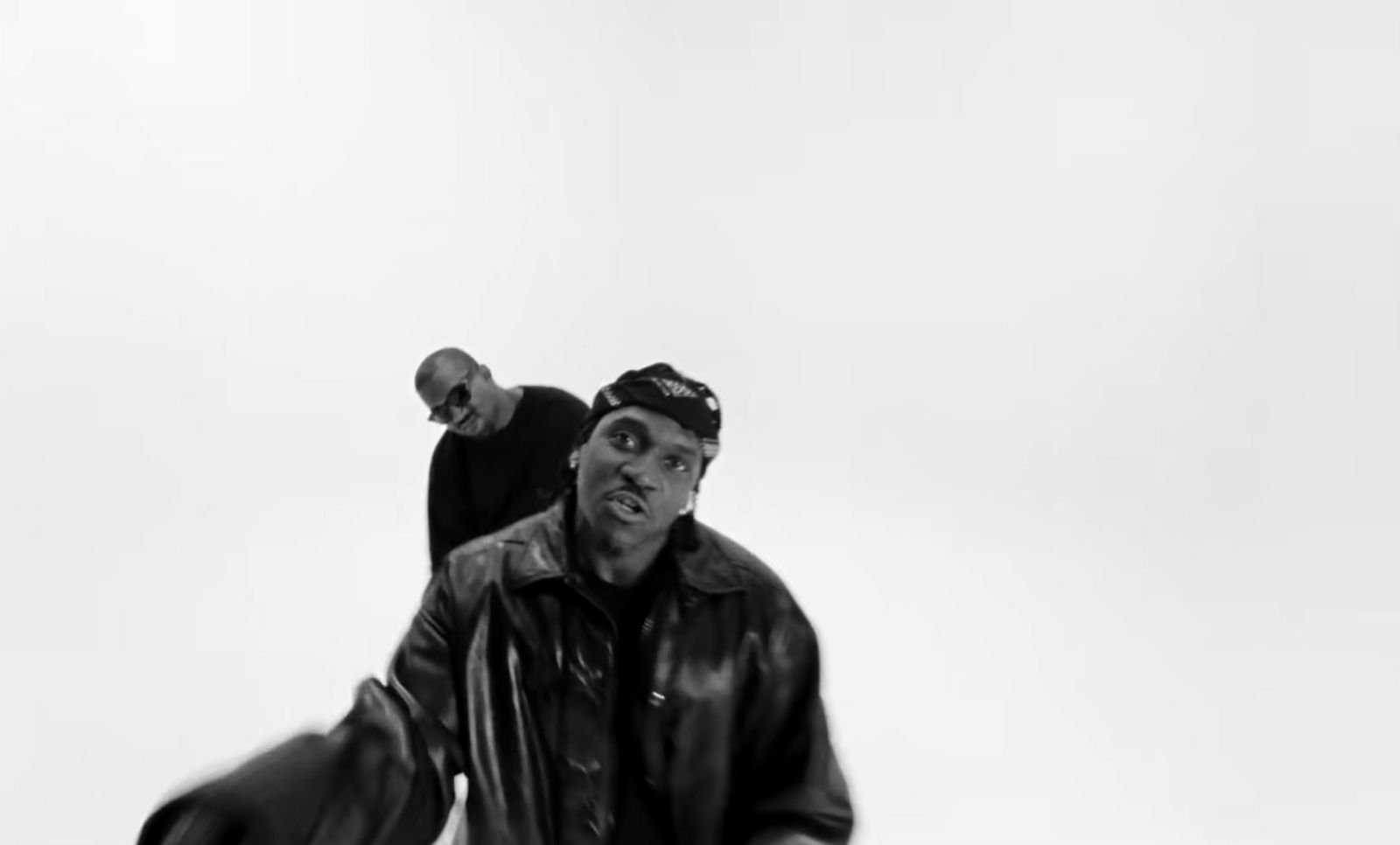 a black and white photo of a man holding a skateboard