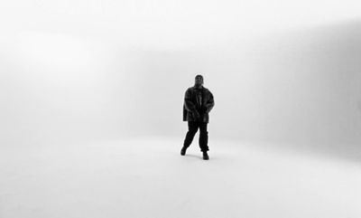 a man standing in the middle of a white room