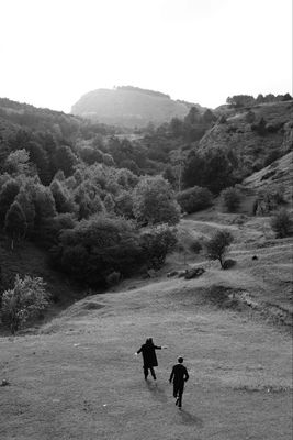 a couple of people that are standing in the grass