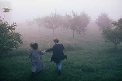 a couple of people that are walking in the grass