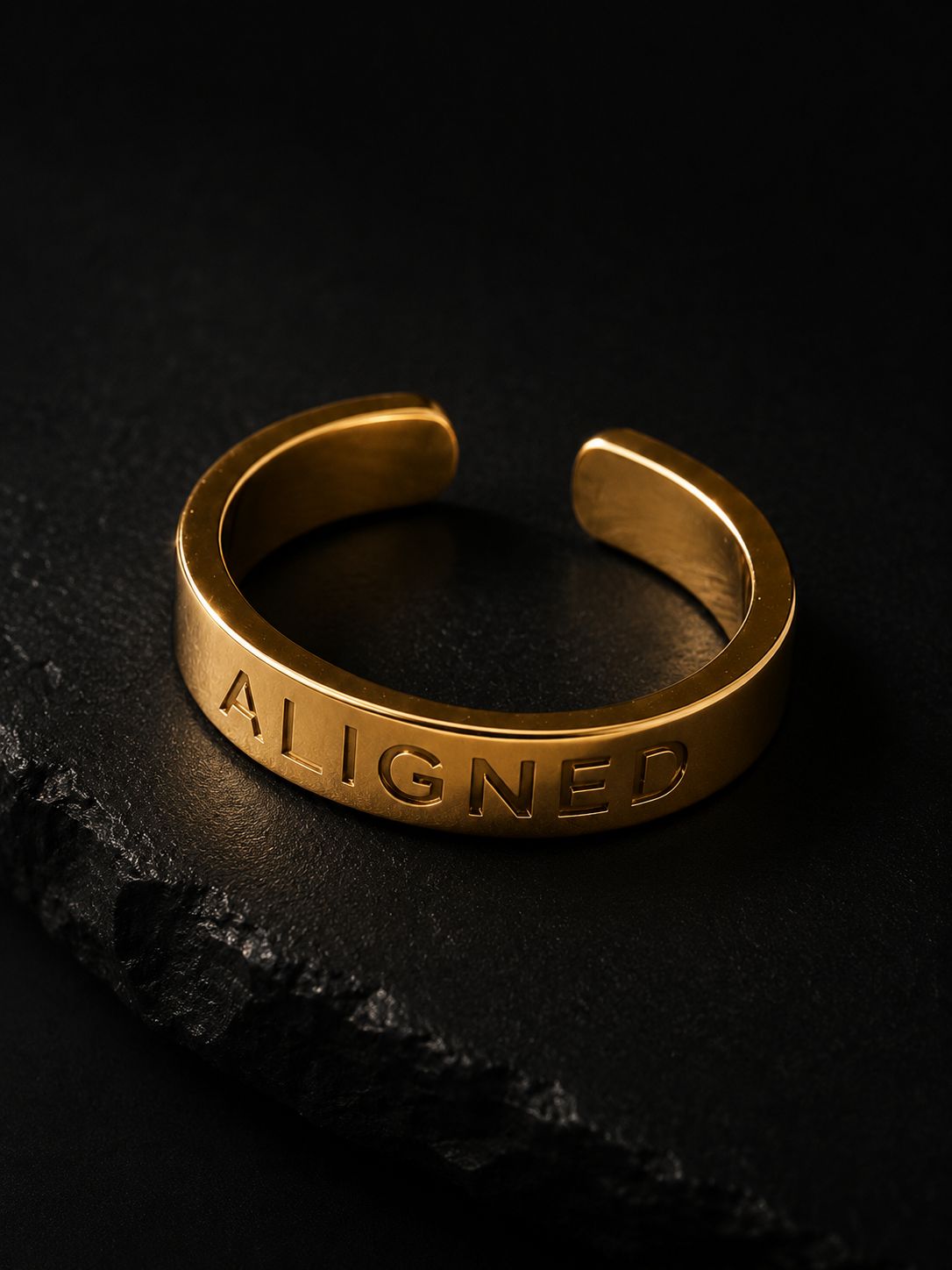 a gold ring with the word aigned engraved on it