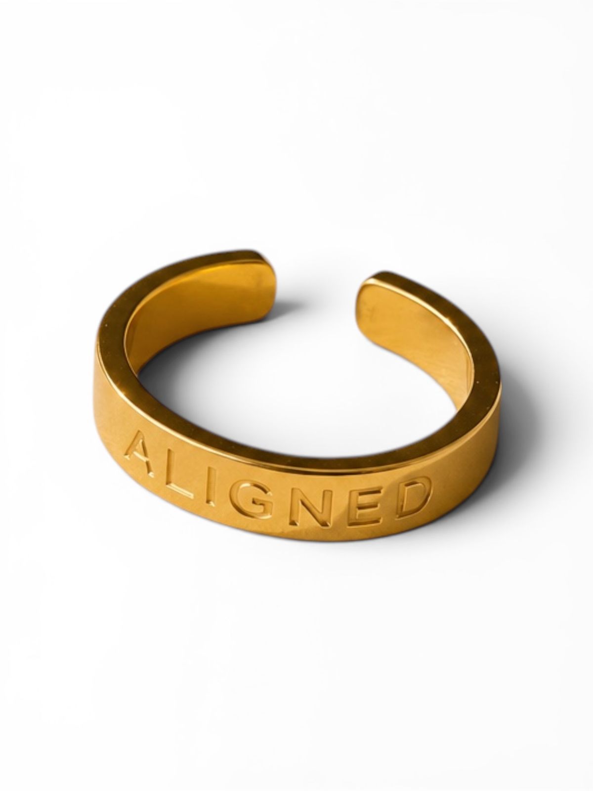 a gold ring with the word aligned on it