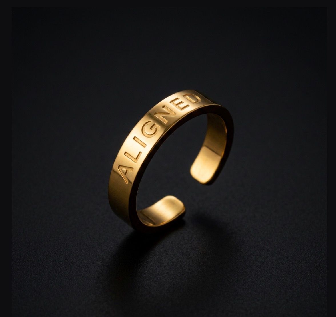 a gold ring with the word alone engraved on it