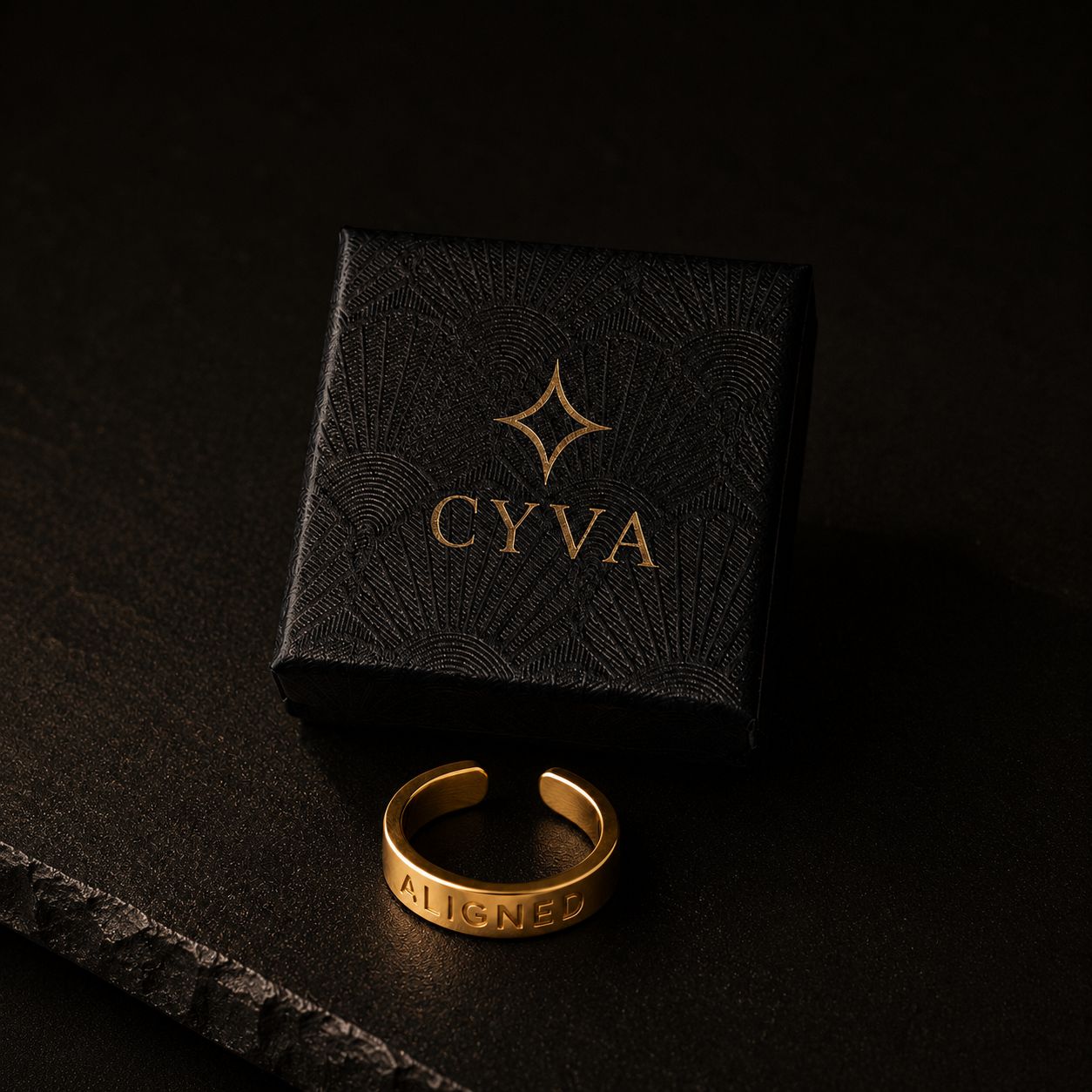a gold ring sitting on top of a black box