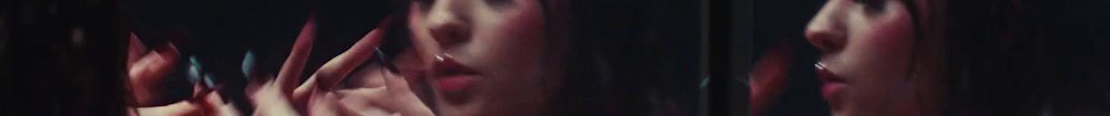 a blurry image of a woman's face with red hair