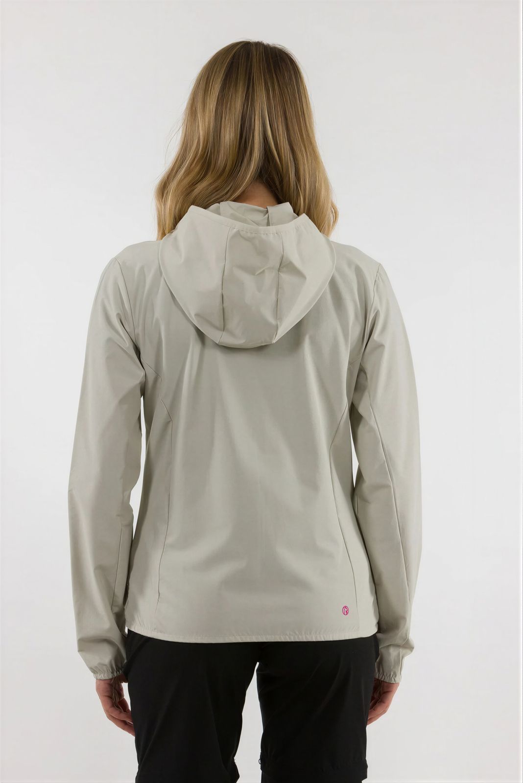 a woman wearing a white jacket and black pants