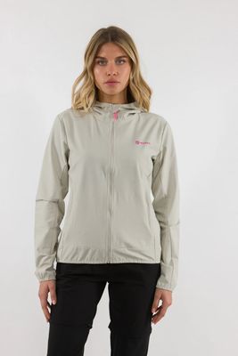 a woman wearing a light gray jacket and black pants