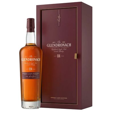 a bottle of whisky sitting next to a wooden box