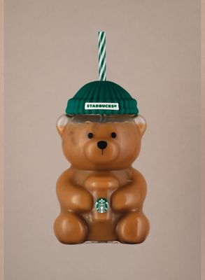 a brown bear ornament with a starbucks hat on