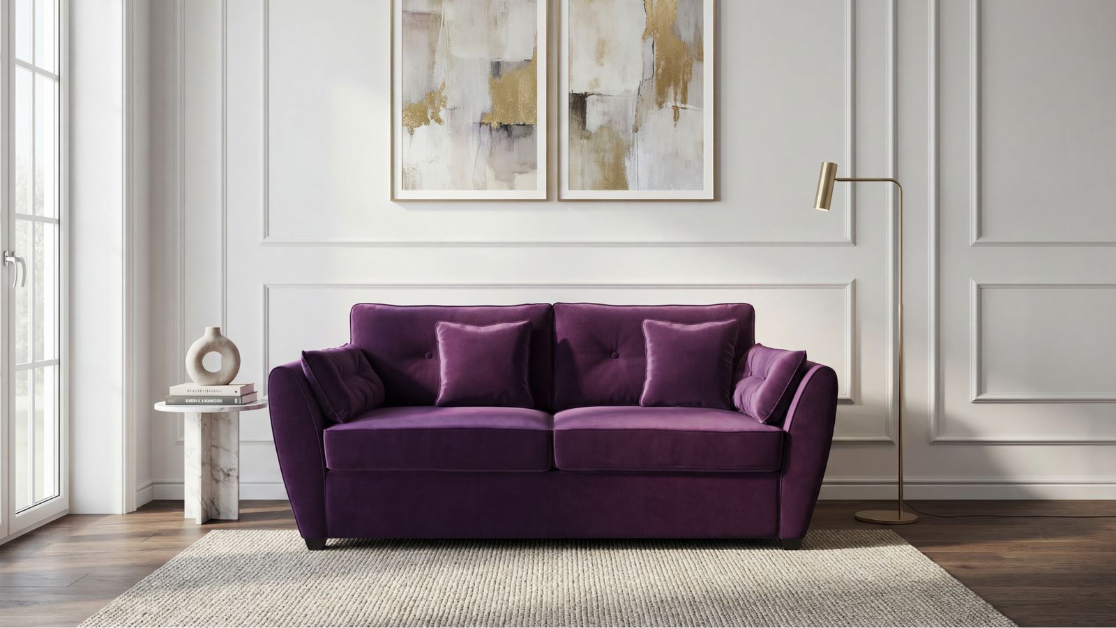a living room with a purple couch and two paintings on the wall