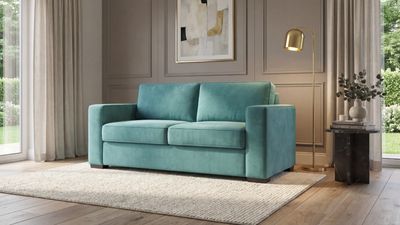 a living room with a blue couch and a rug