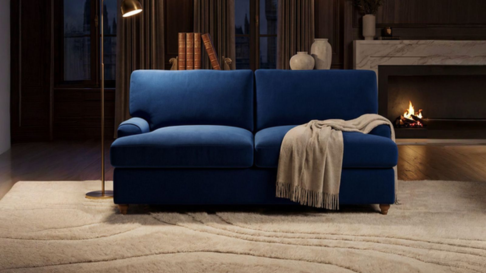 a blue couch sitting in a living room next to a fire place