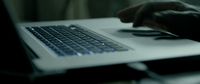 a close up of a person typing on a laptop