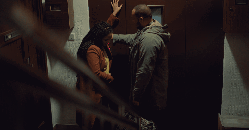 a man and a woman standing in front of a door