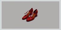 a pair of red shoes sitting on top of a white floor
