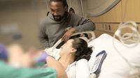 a man standing next to a woman in a hospital bed