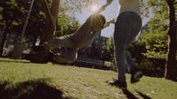 two people playing with a frisbee in a park