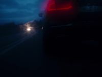 a car driving down a road at night