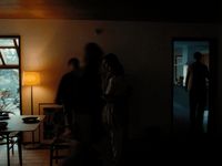 a group of people standing in a dark room