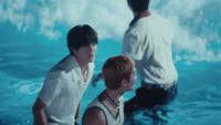 a couple of men standing in the water next to each other