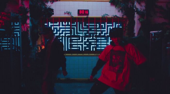 two men walking down a hallway in a building