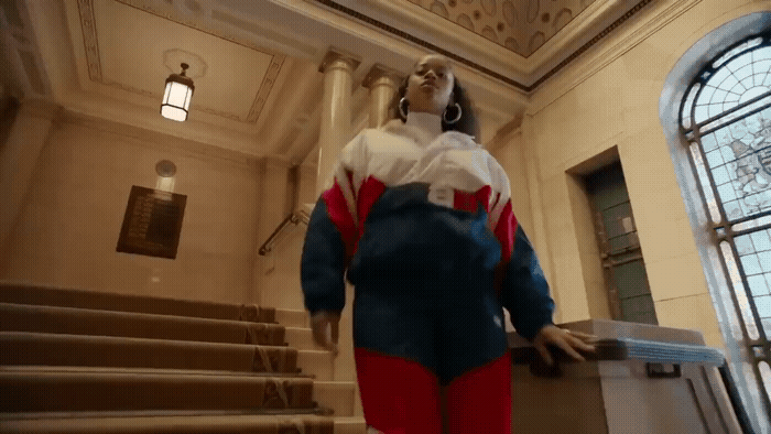 a statue of a woman in a blue and red suit