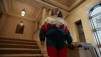 a statue of a woman in a blue and red suit