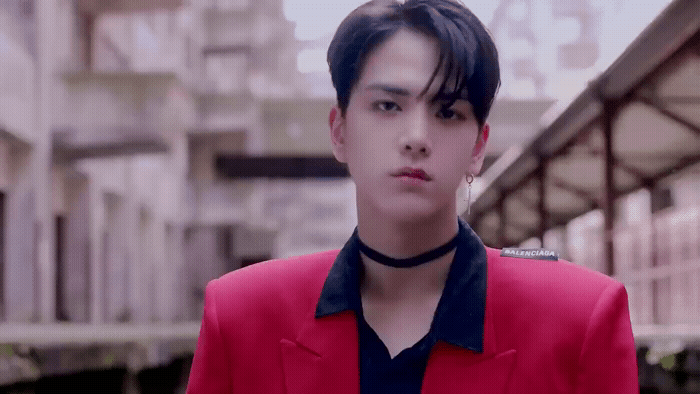 a man in a red jacket and black shirt