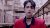a man in a red jacket and black shirt