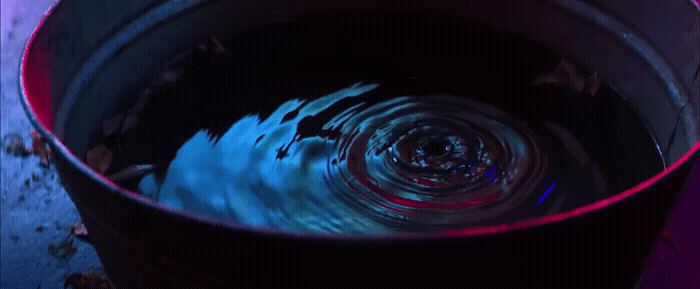 a bucket filled with water sitting on top of a table