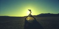 a person standing in the middle of a desert