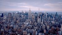 an aerial view of a city with tall buildings