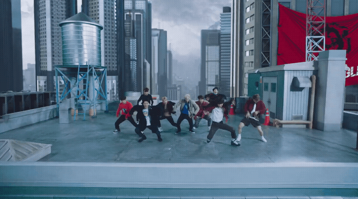 a group of people dancing on top of a roof