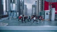 a group of people dancing on top of a roof