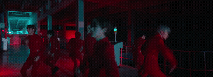 a group of people walking down a hallway at night