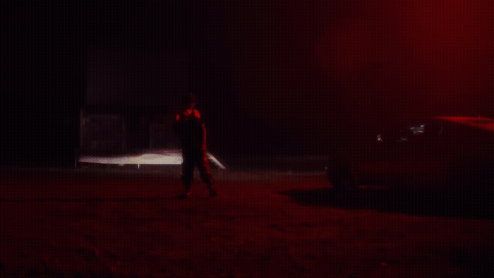 a man standing in the dark with a knife in his hand