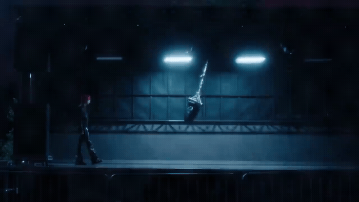 a person standing on a stage in the dark